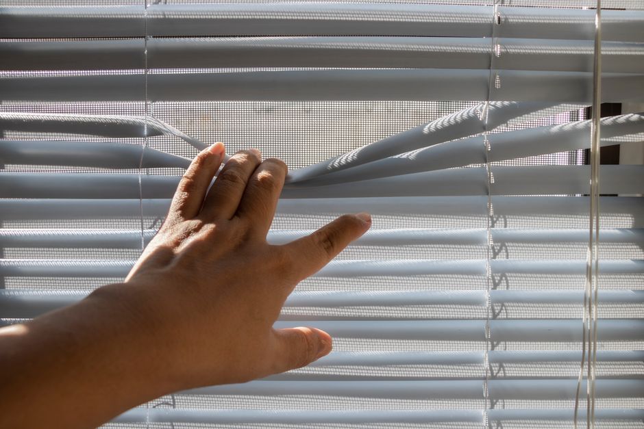 Contractor carefully installing premium window blinds