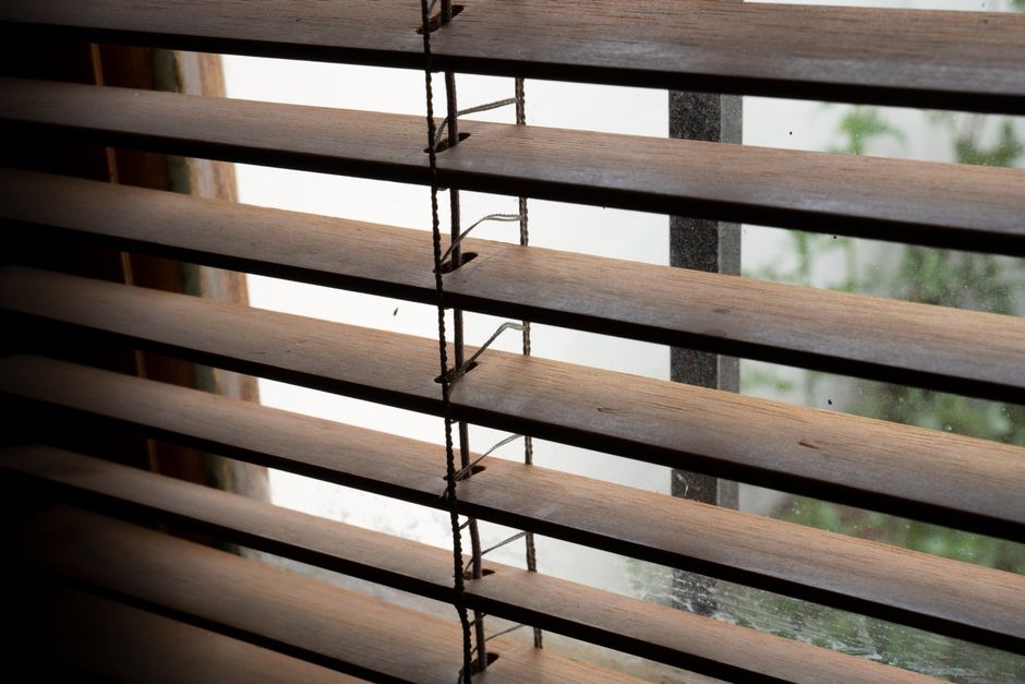 Sunlight filtering through rich wooden blinds